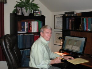 Dr Larry Olsen Sitting at His Desk