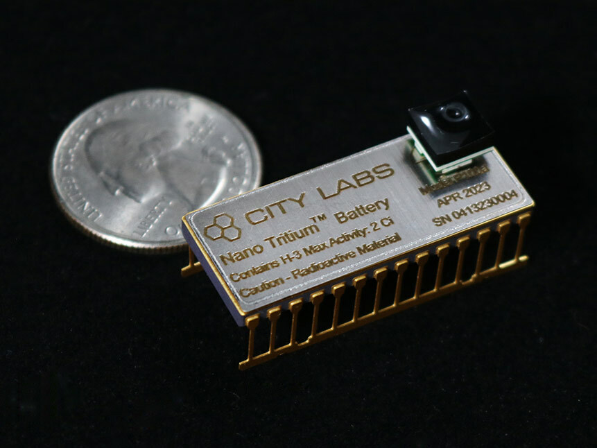 ATM page image of city labs battery next to a quarter for scale of how small it is