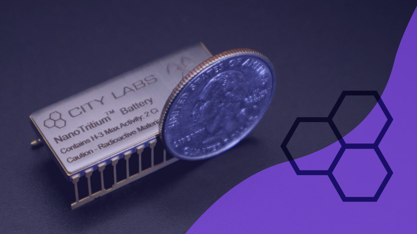 City Lab's Long term power Nanotritium TM battery shown next to a quarter for scale