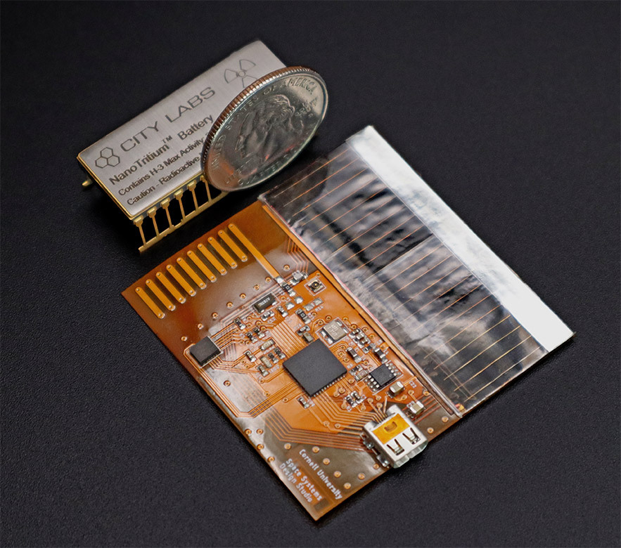 Mason peck case study, image of the chipSat Nanotritium TM battery next to a coin showing it's very small size.